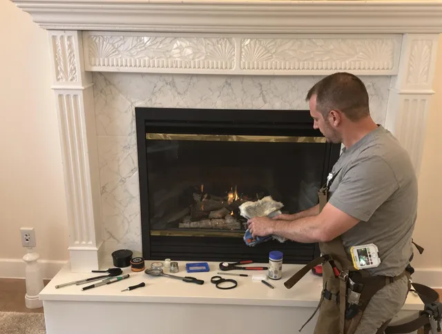 Belmont Chimney Sweep performing fireplace maintenance in Belmont, NC